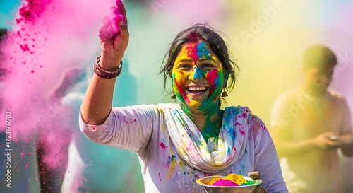 Joyful Indian woman celebrating the vibrant Holi festival of colors.