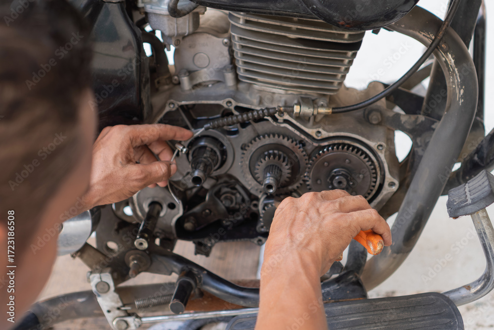 Fototapeta premium Mechanic working on motorcycle engine repair and maintenance