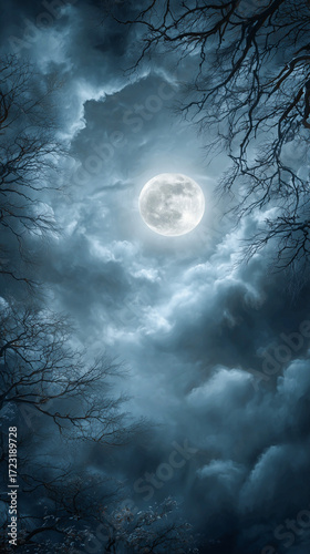 Bright Full Moon Illuminating Dark Cloudy Sky with Bare Twisted Tree Branches in Foreground Silhouette Against Blue Night Horizon