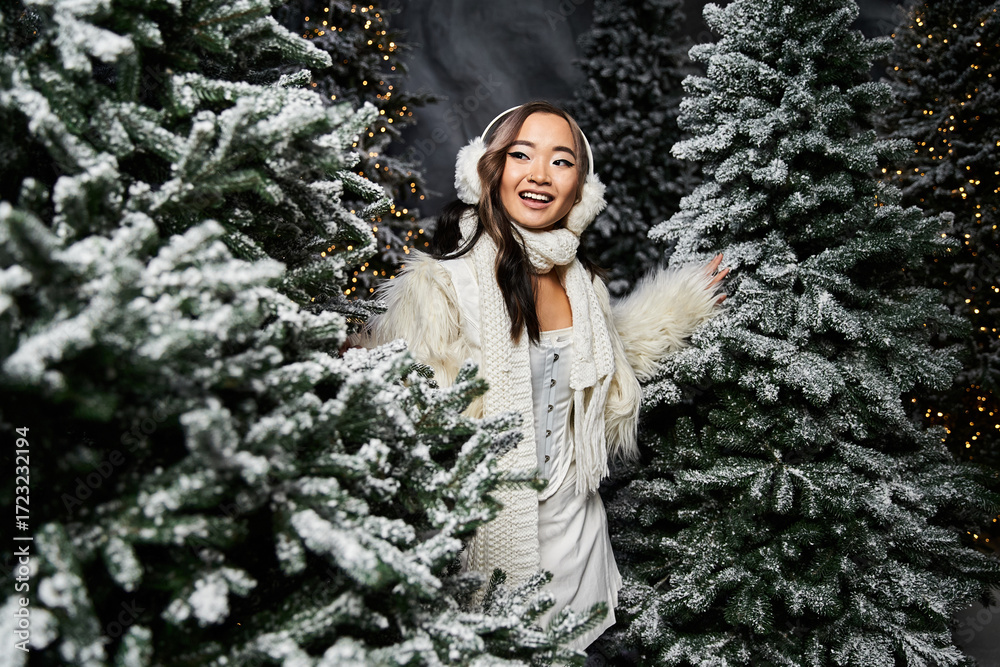 Φωτογραφία Young woman in winter wonderland with faux fur jacket surrounded by snowy trees