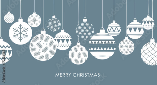 Elegant white Christmas ornaments with festive patterns hang against a serene blue background for holiday greetings and seasonal designs.