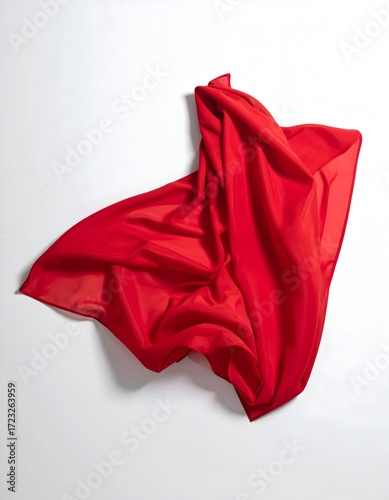 A vibrant red fabric draped loosely on a white background