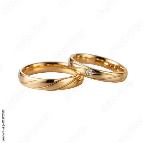 Two gold wedding rings with engraved wave patterns and one diamond gold rings engagement rings on a transparent background