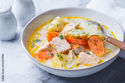 Finnish salmon soup with potatoes, carrots, and cream.