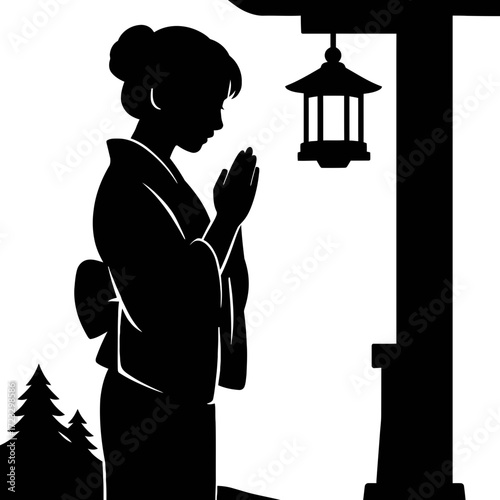 Silhouette woman in kimono praying at traditional Japanese shrine lantern