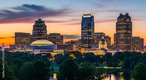 Stunning Sunset Over Raleigh North Carolina Cityscape with Illuminated Buildings and Lush Greenery.
