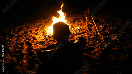 people enjoying a bonfire on the beach