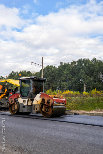 Wallpaper Mural Heavy road roller machine working on fresh asphalt during road construction Torontodigital.ca