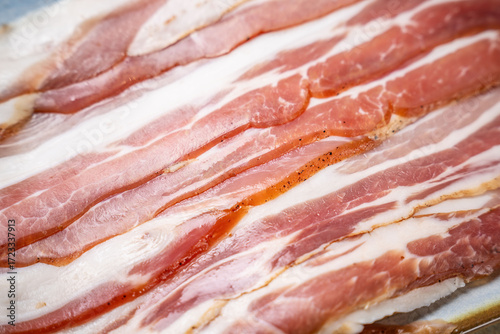 Foto Raw bacon strips with fat marbling