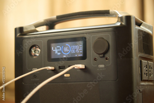 Portable power station charging a phone close-up. Backup energy