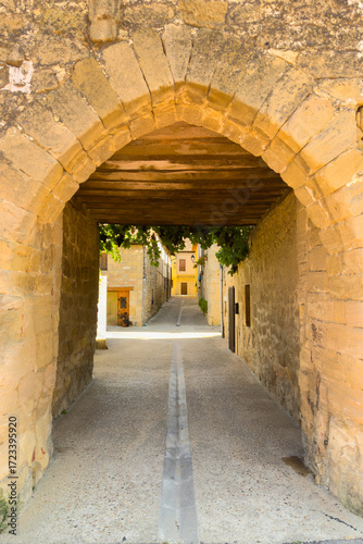 Medieval stone tower in Santa Gadea del Cid, Burgos, Spain, serving as an ancient gateway to the village. Historic defensive architecture from the Middle Ages in northern Spain. High quality photo