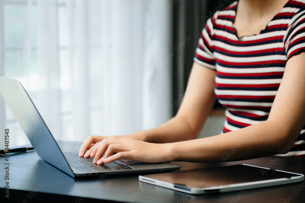 Fototapeta premium Businesswoman hands typing on smartphone and laptop keyboard in morning light computer, typing, online in office