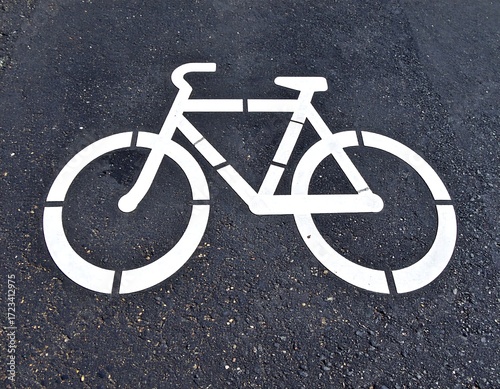 White bicycle symbol on dark asphalt