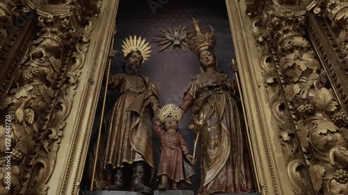 ornate golden altar with statues of the holy family inside a historic catholic church