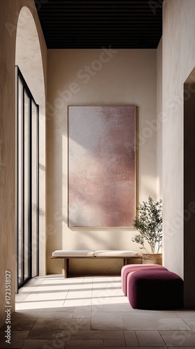 Sunlit hallway with minimalist seating and large abstract art.  Neutral tones create a serene atmosphere