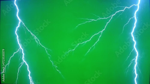 Powerful electric lightning bolt strike creating bright white energy discharge with multiple branches on a chroma key green screen background for easy compositing.

