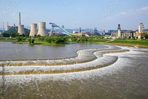old power plant by river in the city