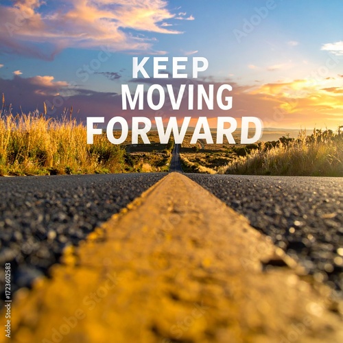 Inspirational message along an open road at sunrise reminding travelers to keep moving forward