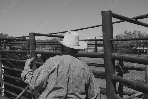 Cowboy during cattle works on New Mexico ranch in black and white.