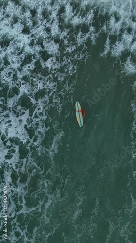 the surfer is swimming