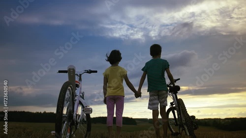 Evening Embrace: Kids Celebrating with a Hug After a Playful Bike Ride in the Sunset