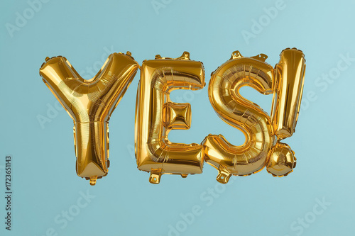Golden Foil Balloons Spelling YES on Blue Background
