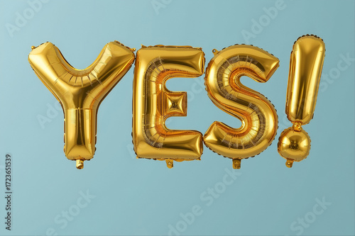 Golden Foil Balloons Spelling YES on Blue Background