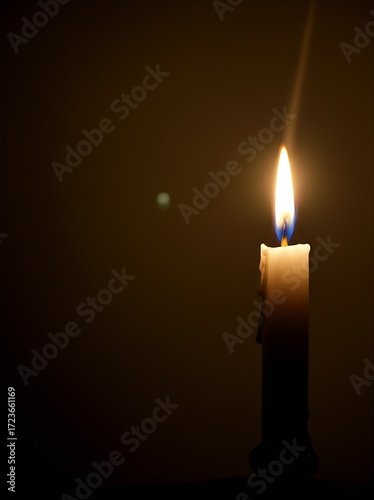 A single lit candle casts long, dancing shadows in a dark, spooky room, initially appearing monstrous but revealed as mere shapes upon closer inspection.