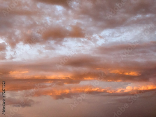 Evening sky. Summer, the sun is already at the horizon, softly illuminating the clouds, a beautiful landscape of the sky,