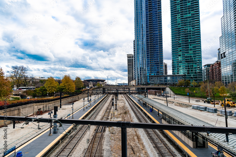 Fototapeta premium Chicago, Illinois, USA - November 10, 2024: Railroad urban transport. Urban train rail. Rail for metro. Railway station with city skyscraper cityscape. Urban modern cityscape. Metro railway station