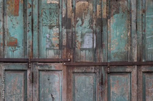 Abandoned old style doors with metal strips lock