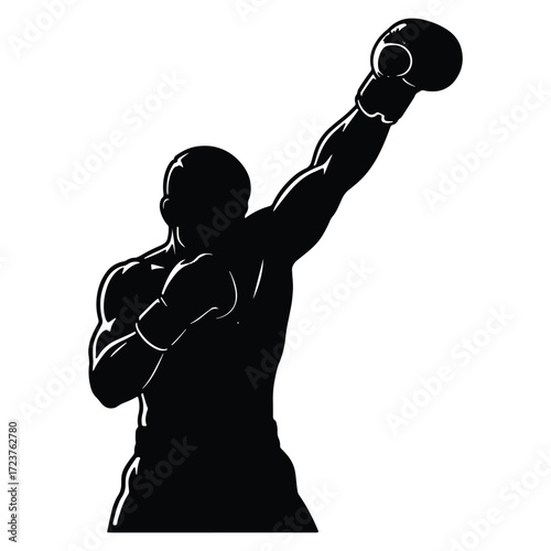 Silhouette of a strong boxer raising his arm in victory pose