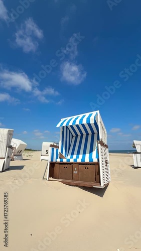Blue and White Striped Beach Chair by the Sea, Capturing the Essence of a Bright Summer Day