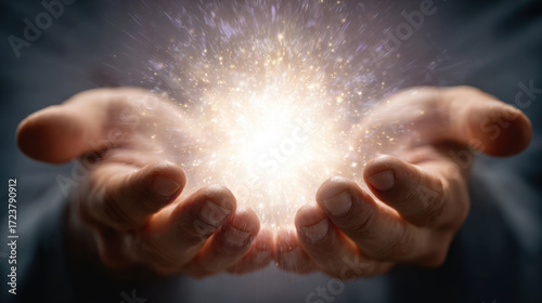 Glowing light surrounded by sparkling particles held in two hands against a dark background, featuring a sense of wonder and a mystical aura radiating energy.