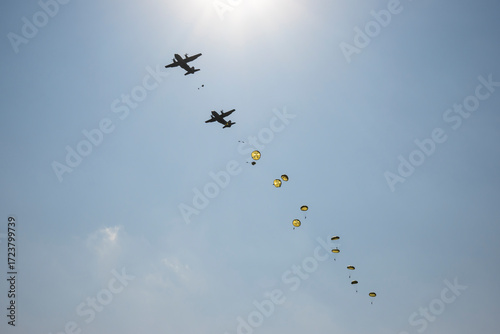 Military paratroopers jumping out of a military plane
