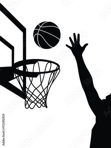 Silhouette of basketball player shooting a ball into a hoop