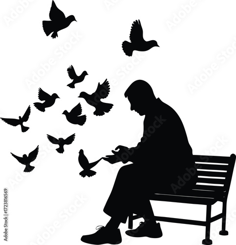 Silhouette of a man feeding pigeons in a park setting