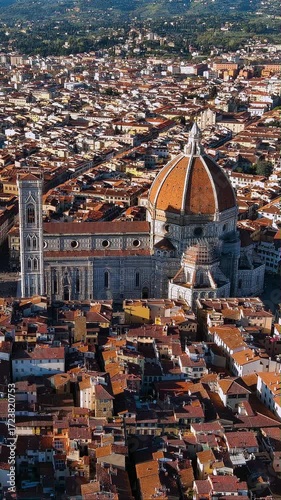 Vertical 4K drone video Florence Cathedral Duomo and Brunelleschi's dome above terracotta rooftops. Iconic aerial footage of Renaissance masterpiece and Tuscan cityscape for mobile video platforms.
