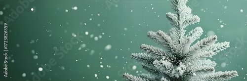 Winter Scene With Snow-Covered Tree and Falling Snowflakes Creating a Festive...