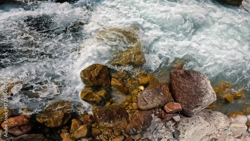 Powerful mountain stream among rocks and boulders