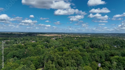 Aerial view of Genappe municipality and city of Wallonia located in the Belgian province of Walloon Brabant. Villas with garden surrounded by forest.