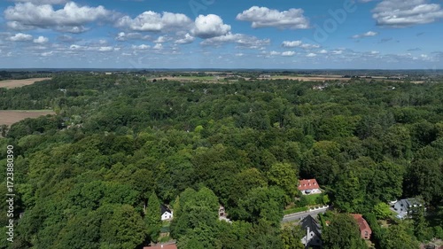 Aerial view of Genappe municipality and city of Wallonia located in the Belgian province of Walloon Brabant. Villas with garden surrounded by forest.
