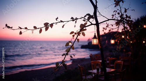 a cozy romantic street cafe next to a park or on the seashore. the beginning of the sunset, tables with vases and candles