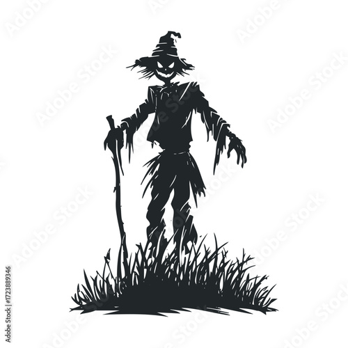 Black silhouette of a scary scarecrow in tall grass.  
