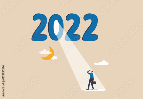 Year 2022 business opportunity, bright future on economic recovery, hope or motivation to overcome difficulty concept, year 2022 with bright spotlight from number zero light up on hopeful businessman.