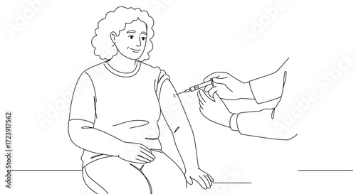 Woman receiving a vaccine injection in her arm by a doctor.