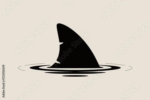 Sleek black shark fin emerges from calm water, symbolizing danger and mystery