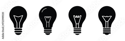 Four black silhouette light bulbs with different filament designs, isolated on white background
