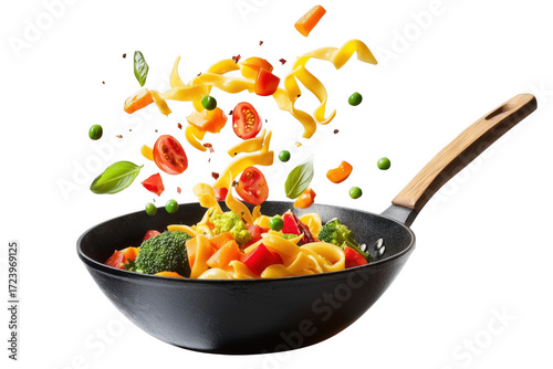 Vibrant pasta dish with fresh vegetables tossed in a black wok isolated on transparent background