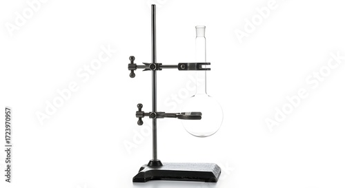 A laboratory setup featuring a round-bottom flask clamped to a retort stand against a white background.